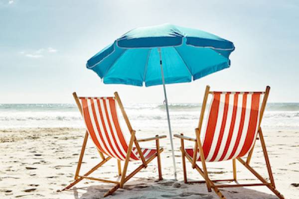 red and white beach chairs with blue umbrella