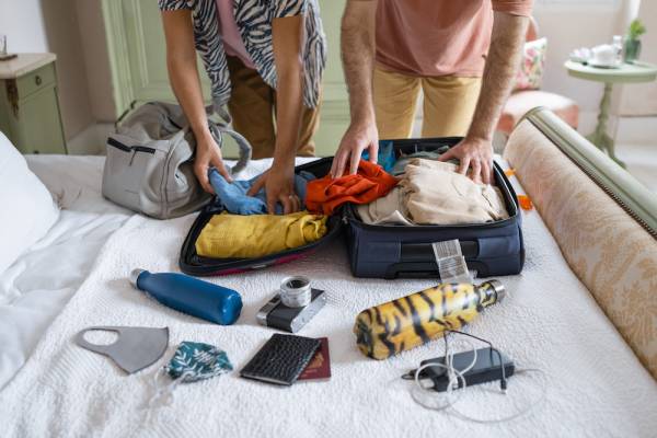 two women packing suitcase