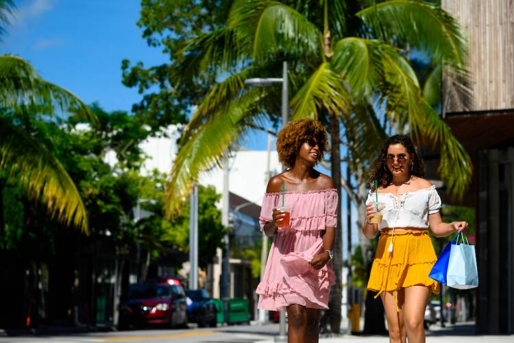 two women shopping at outdoor retail area