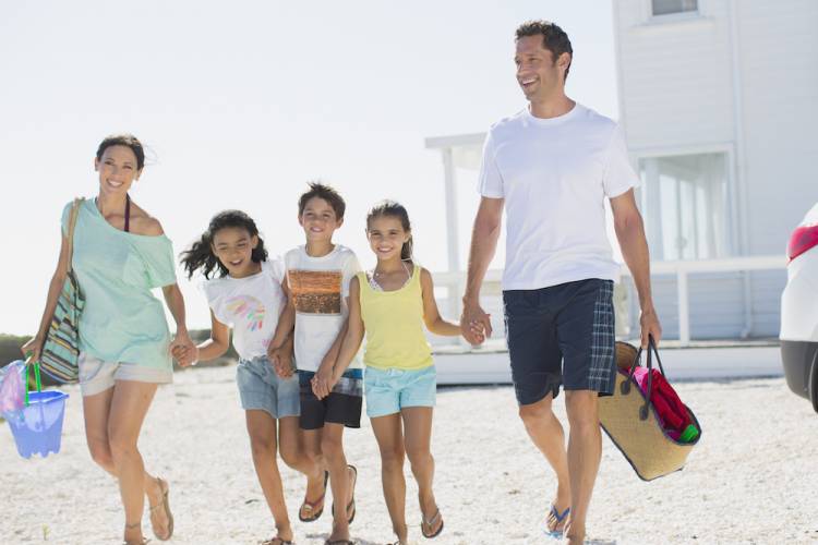 family walking outside at the beach