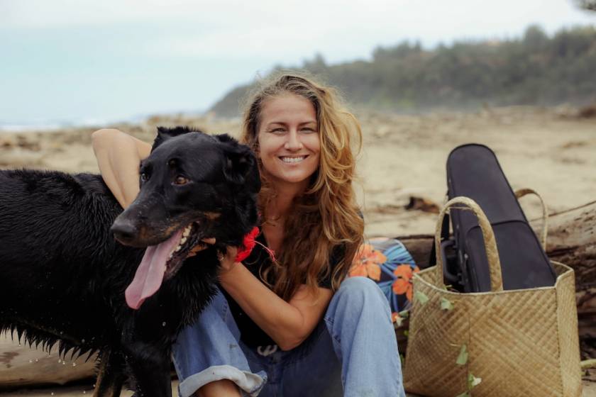woman with her dog on the beach