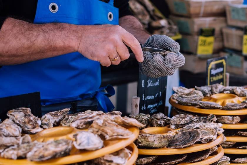 man shucking oysters
